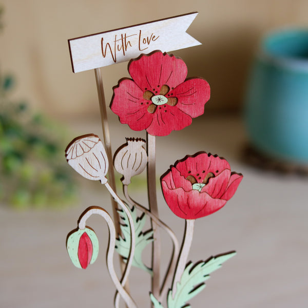 Three Poppy Stems in a Terracotta Pot
